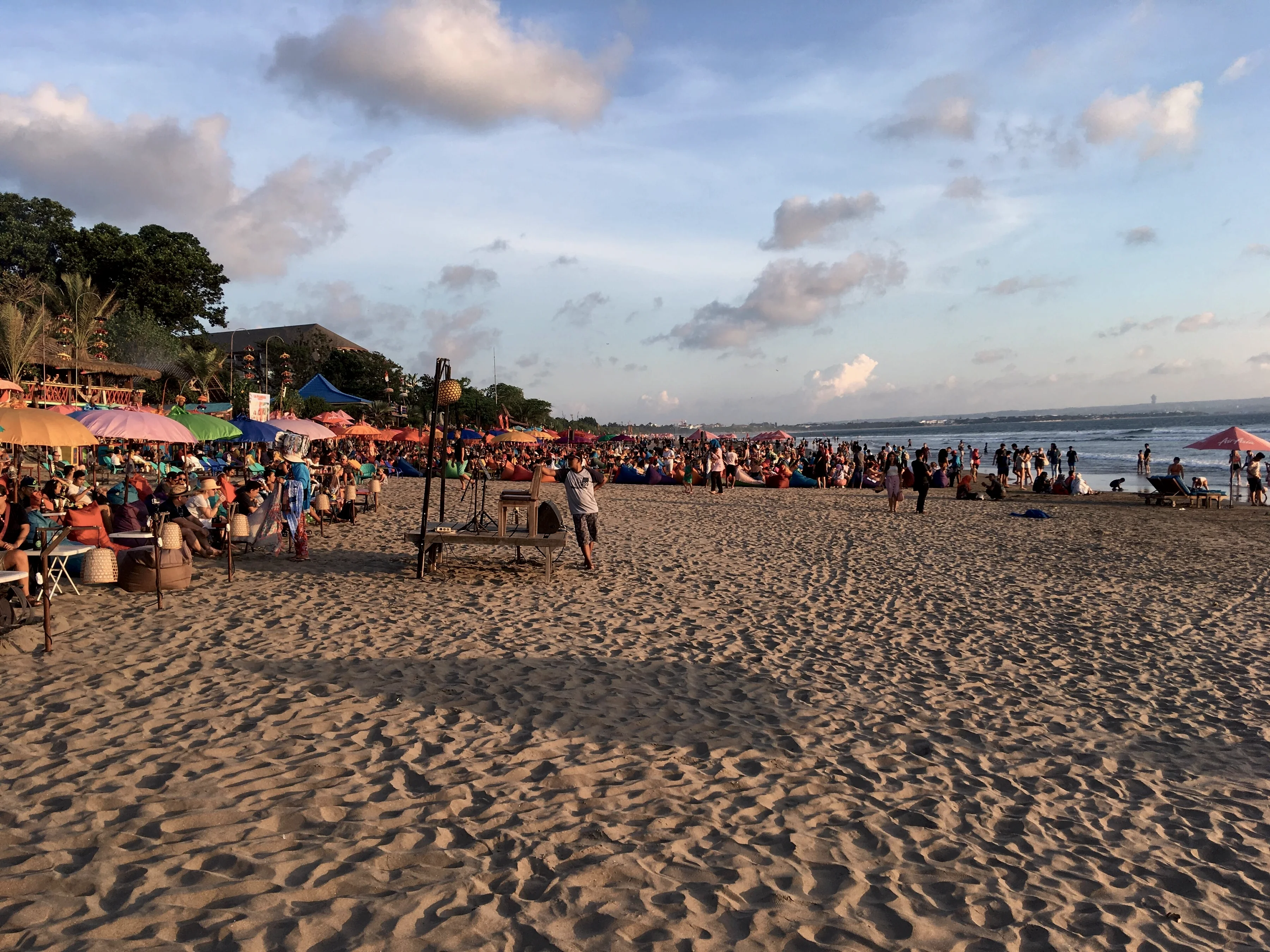 Beach bars and umbrellas on Seminyak beach in the afternoon