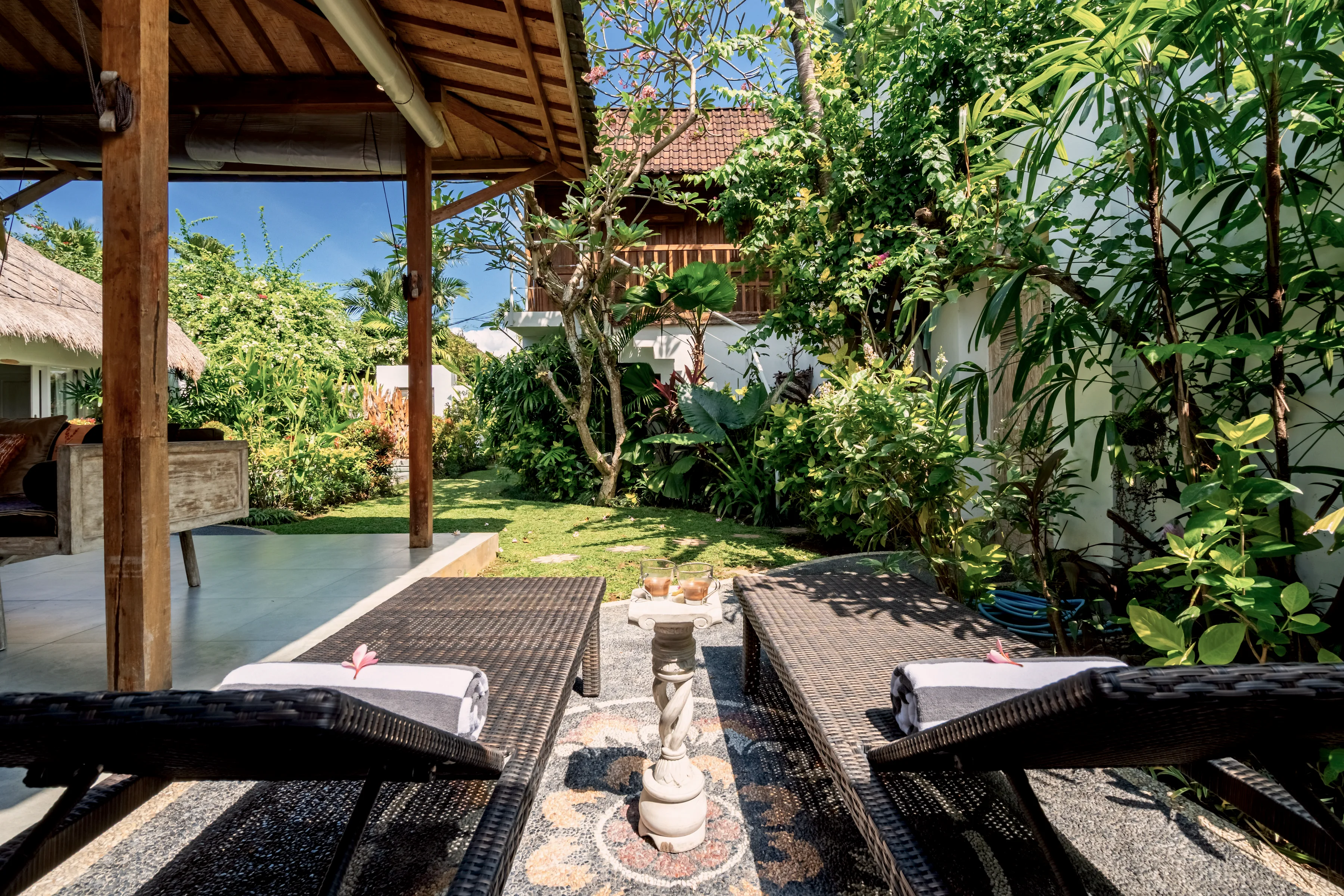 Teak loungers and folded towels beside the pool