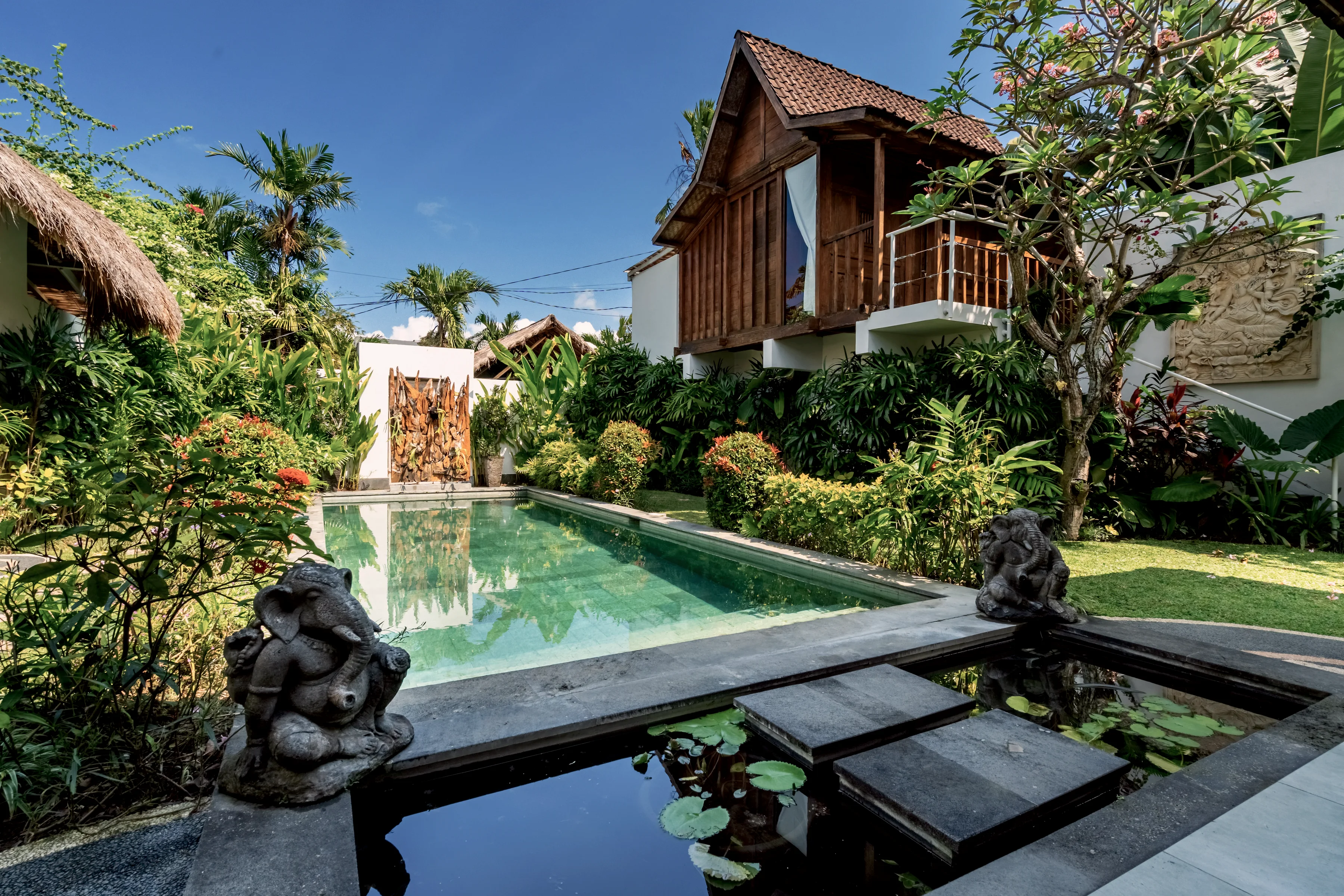 Stepping stones across the pool, lily pads at the near end