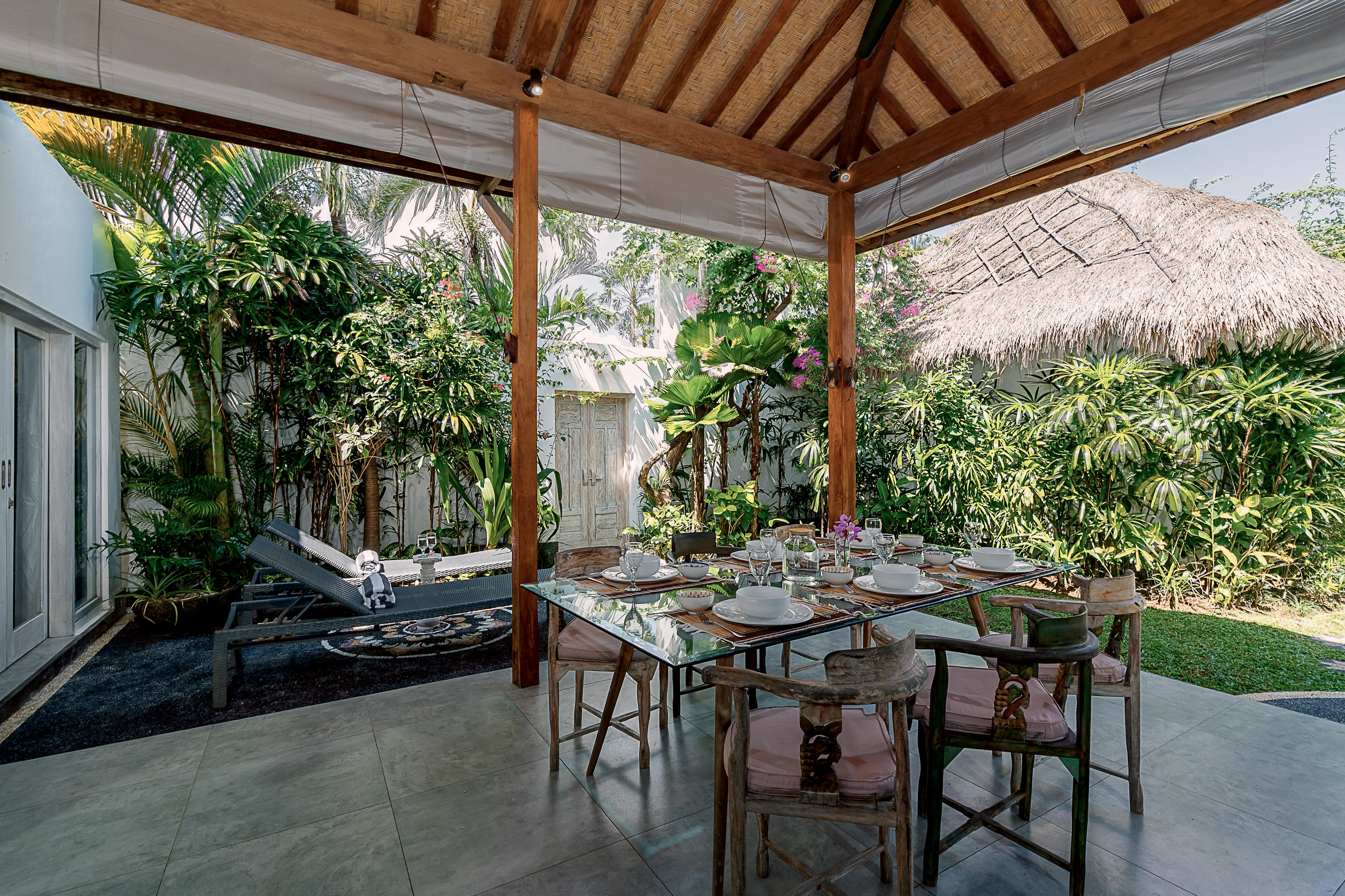 The table laid with plates and glasses, open to the garden