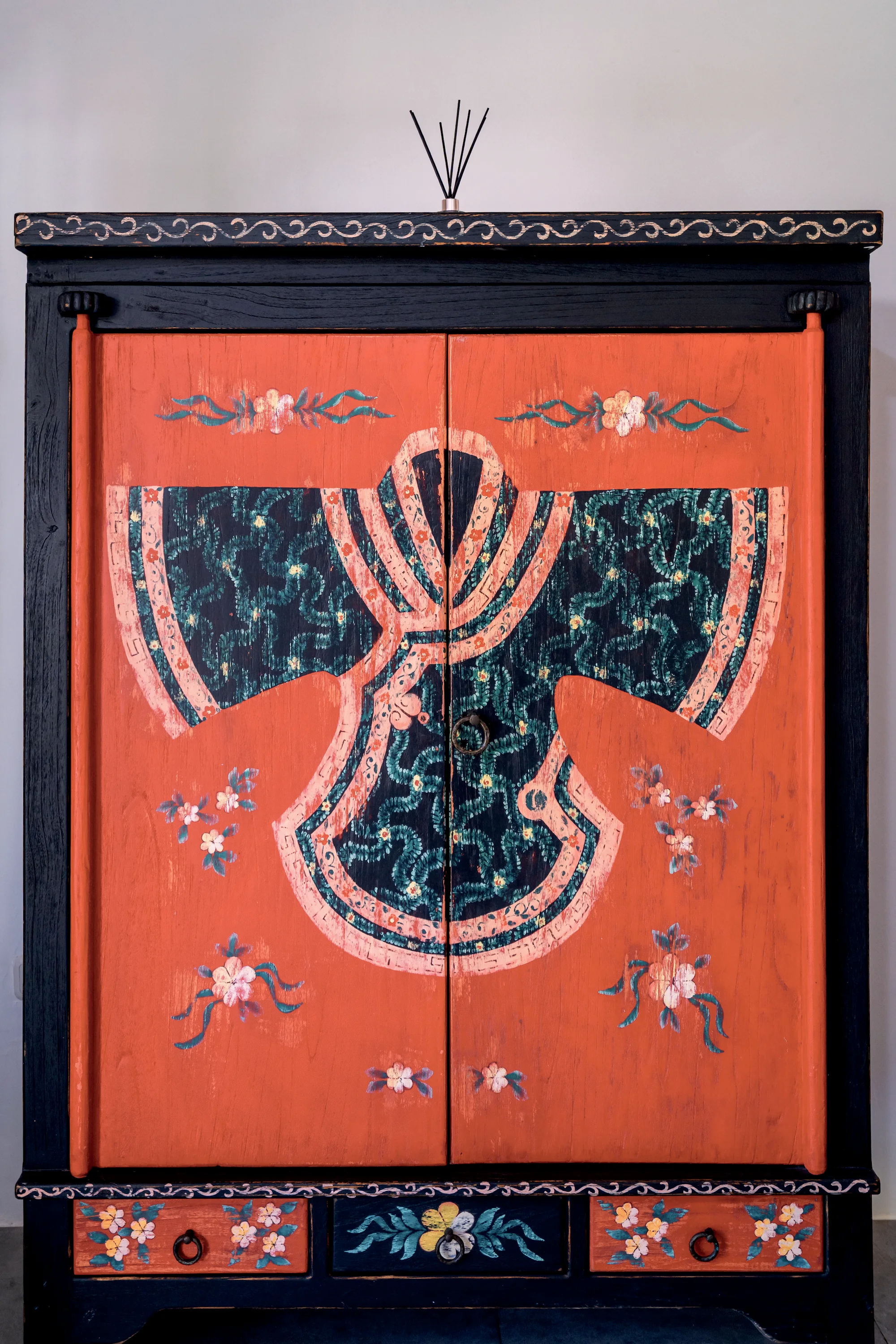 The doors of the red cabinet, painted with a robe of flowers