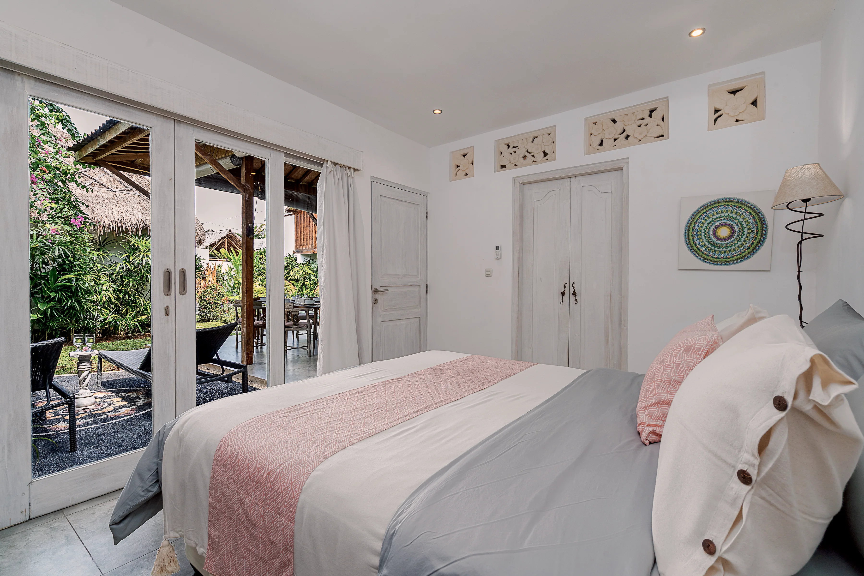 The bed facing glass doors onto the garden